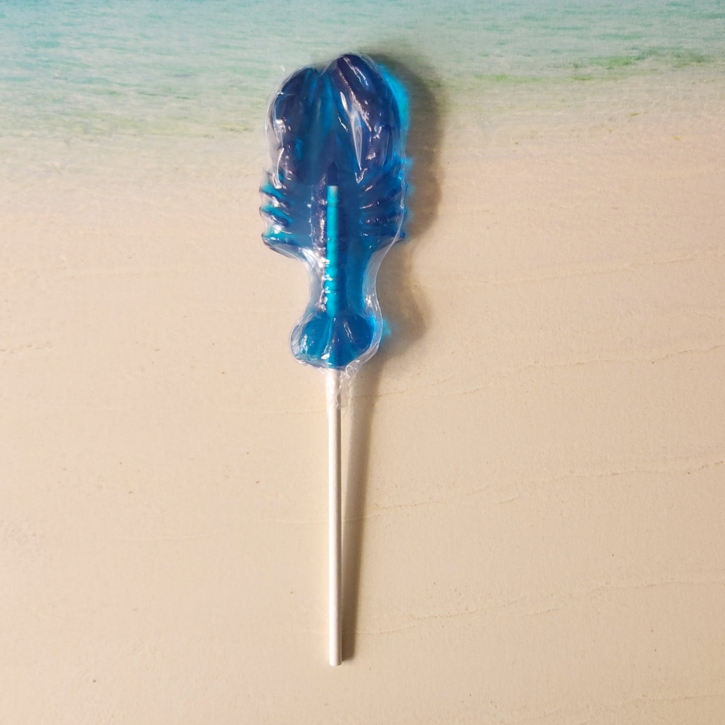 Blue raspberry flavored hard candy pop in the shape of a lobster.