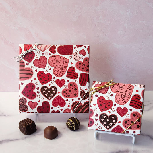 An assortment of our most popular milk and dark chocolate creams, caramels, melt-aways, and truffles all packed inside a festive box. On the cover of the box bright hearts are printed.