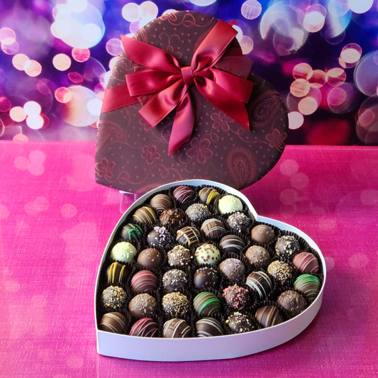 Give the ultimate gift of love this Valentine’s Day with our Truffle Heart, a luxurious assortment of handcrafted chocolate truffles.  This 41 piece  heart-shaped box is filled with an irresistible variety of creamy, decadent truffles. From classic flavors to unique creations, every bite is a delightful surprise that’s sure to melt hearts