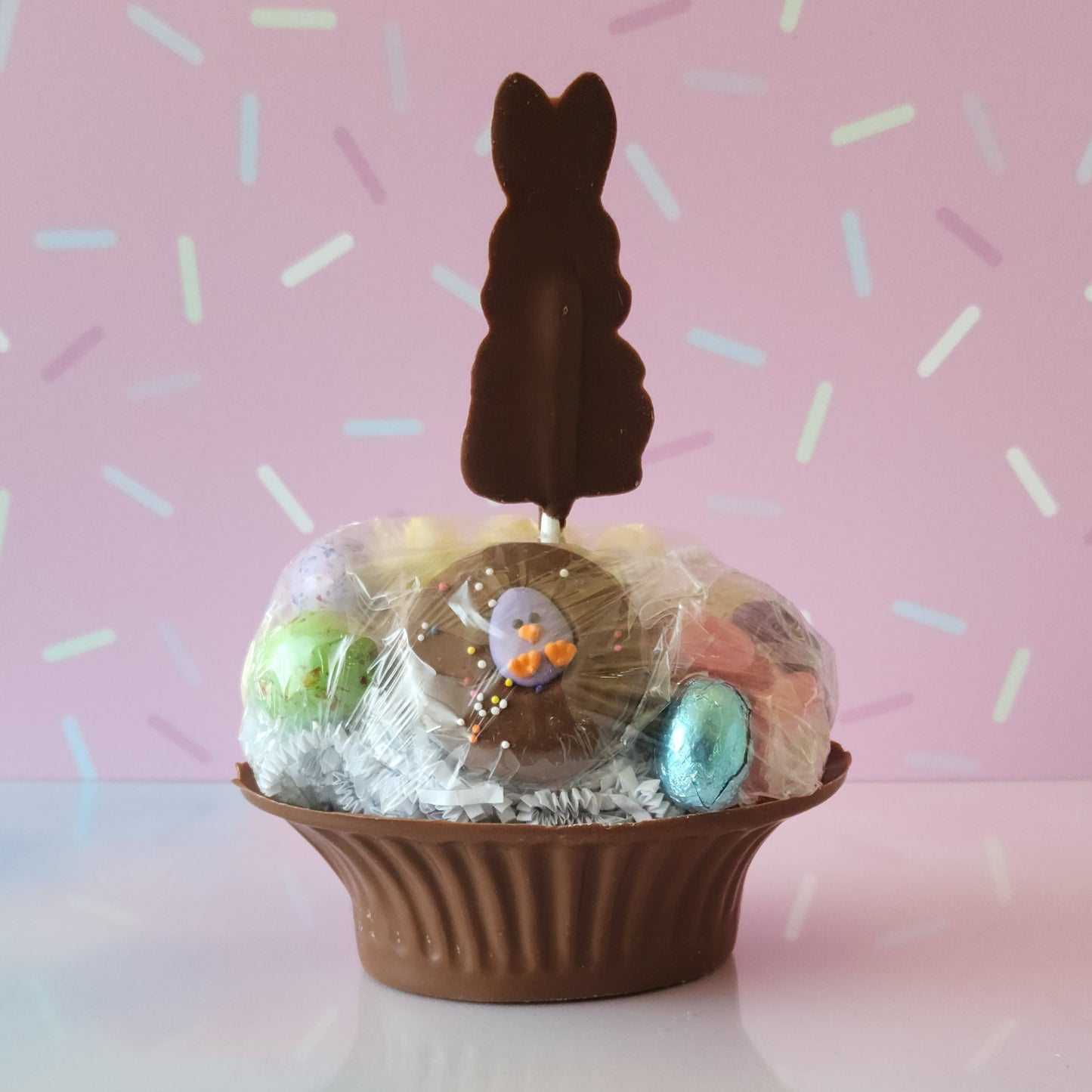 Our Medium Chocolate Basket is made of Milk chocolate. We then fill it with fruit flavored jelly beans, soft marshmallow Peeps, chocolate foiled eggs, speckled malt eggs, and a chocolate covered Oreo. To finish the look a chocolate Easter Bunny pop stands on top.
***Due to its fragile nature this item is only available for in-store pick-up. It can not be shipped***