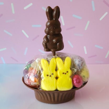 Our Medium Chocolate Basket is made of Milk chocolate. We then fill it with fruit flavored jelly beans, soft marshmallow Peeps, chocolate foiled eggs, speckled malt eggs, and a chocolate covered Oreo. To finish the look a chocolate Easter Bunny pop stands on top.
***Due to its fragile nature this item is only available for in-store pick-up. It can not be shipped***