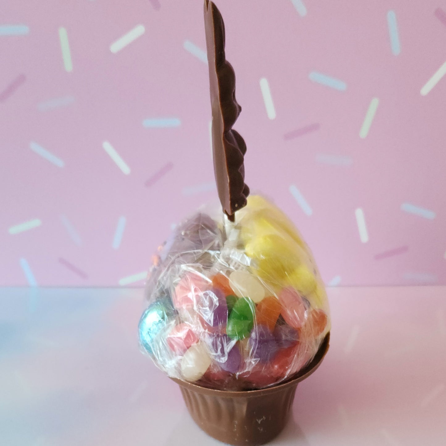 Our Medium Chocolate Basket is made of Milk chocolate. We then fill it with fruit flavored jelly beans, soft marshmallow Peeps, chocolate foiled eggs, speckled malt eggs, and a chocolate covered Oreo. To finish the look a chocolate Easter Bunny pop stands on top.
***Due to its fragile nature this item is only available for in-store pick-up. It can not be shipped***