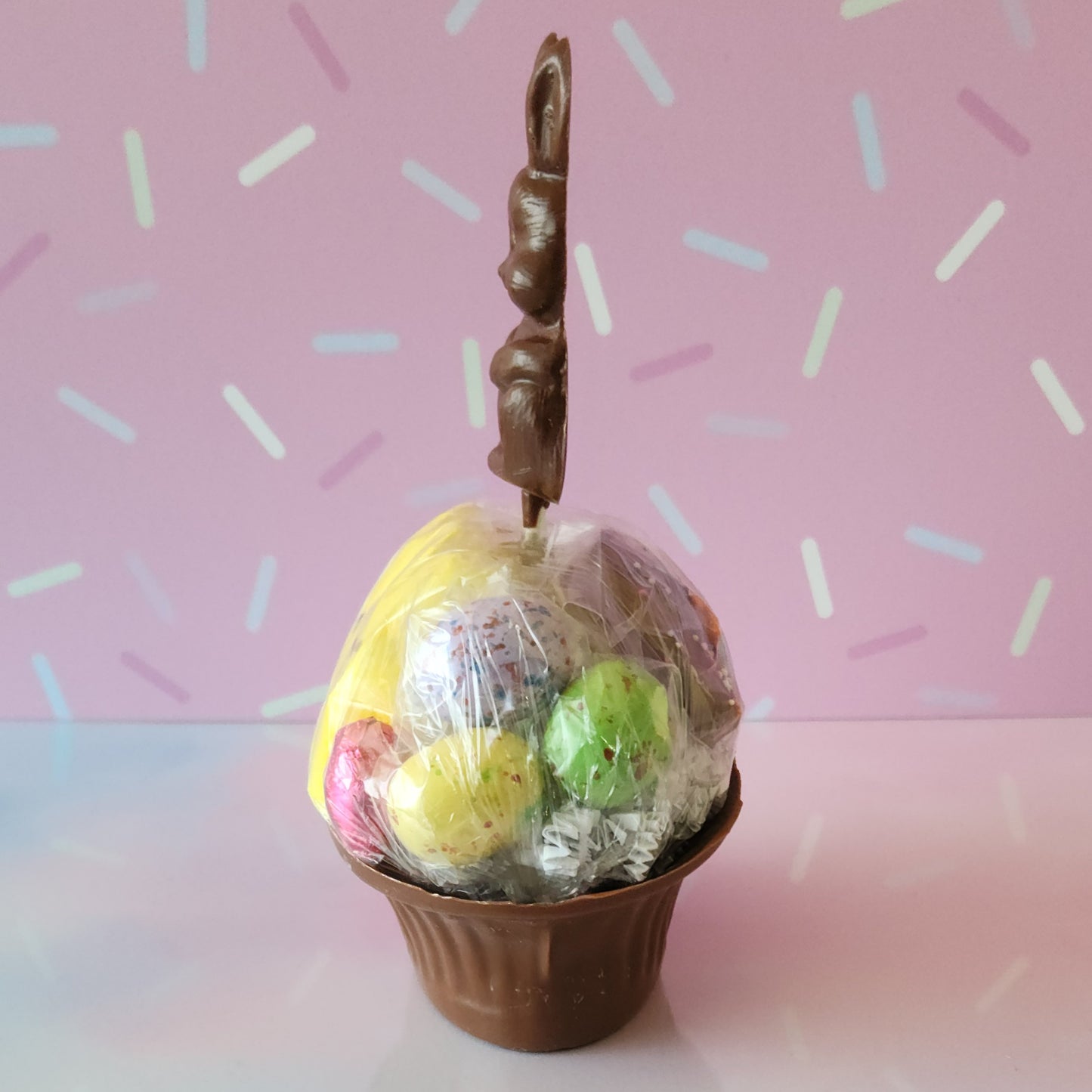 Our Medium Chocolate Basket is made of Milk chocolate. We then fill it with fruit flavored jelly beans, soft marshmallow Peeps, chocolate foiled eggs, speckled malt eggs, and a chocolate covered Oreo. To finish the look a chocolate Easter Bunny pop stands on top.
***Due to its fragile nature this item is only available for in-store pick-up. It can not be shipped***