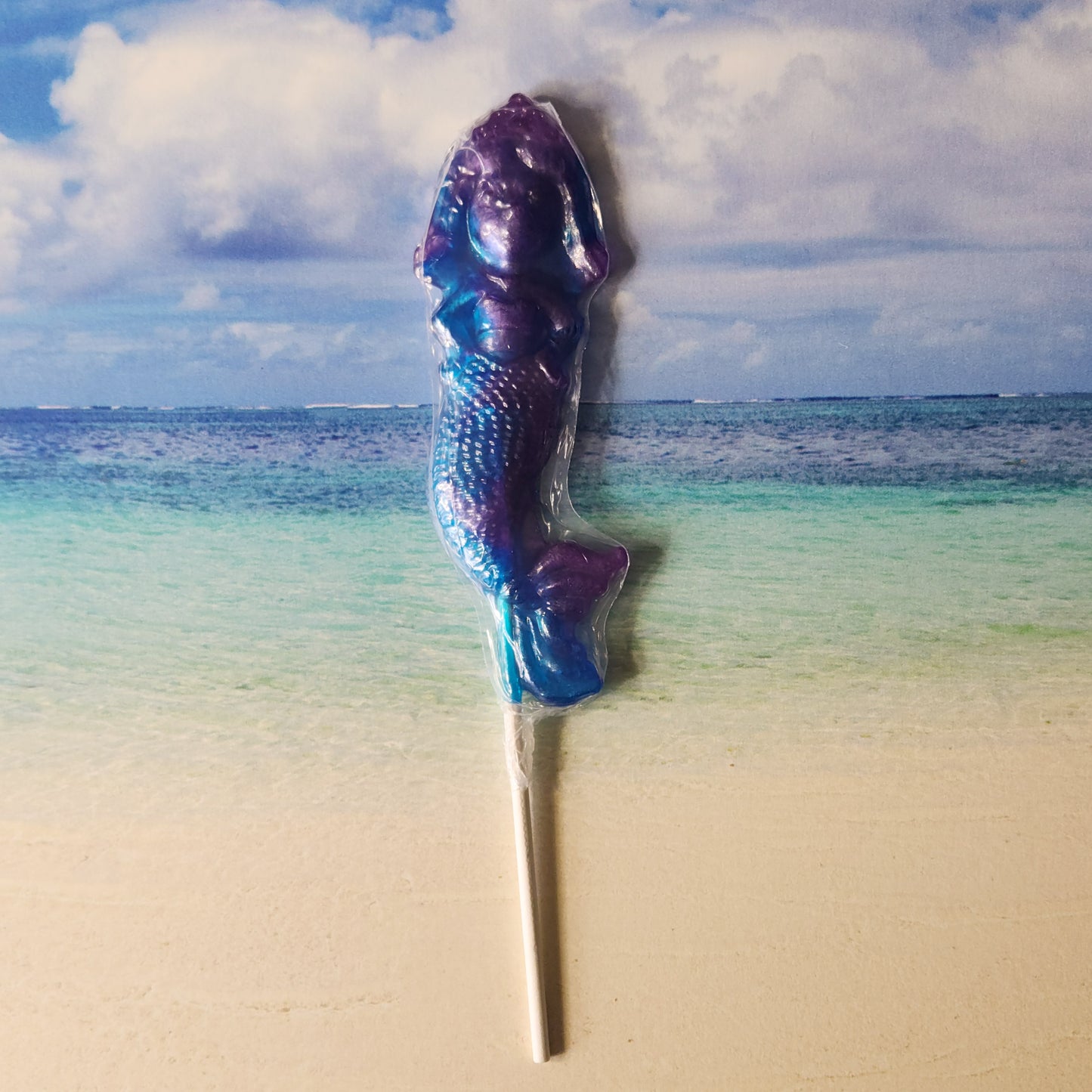 Blue Raspberry and Grape Flavored hard candy lollipop in the shape of a mermaid.