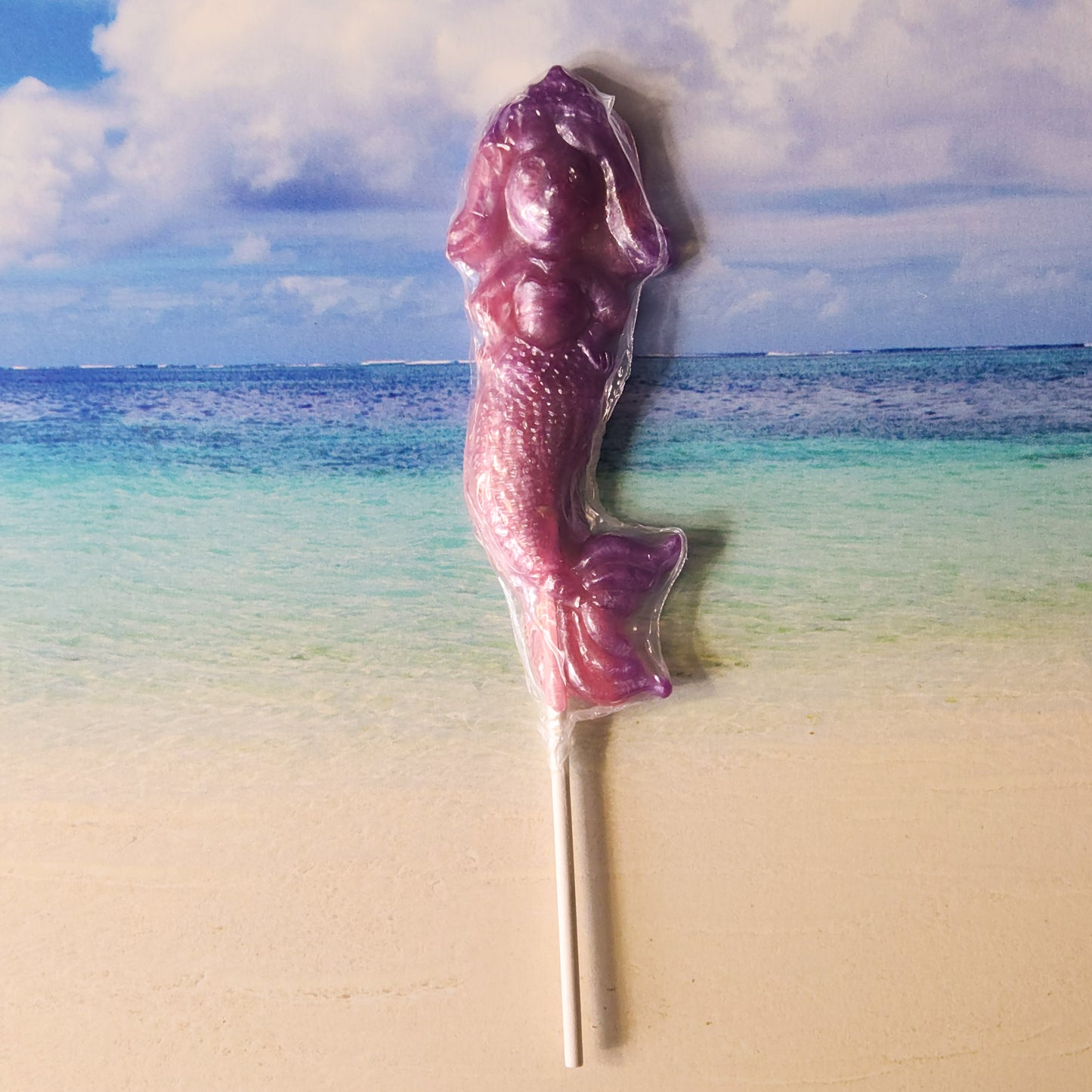 A Strawberry Grape flavored Hard Candy Lollipop in the shape of a Mermaid. 