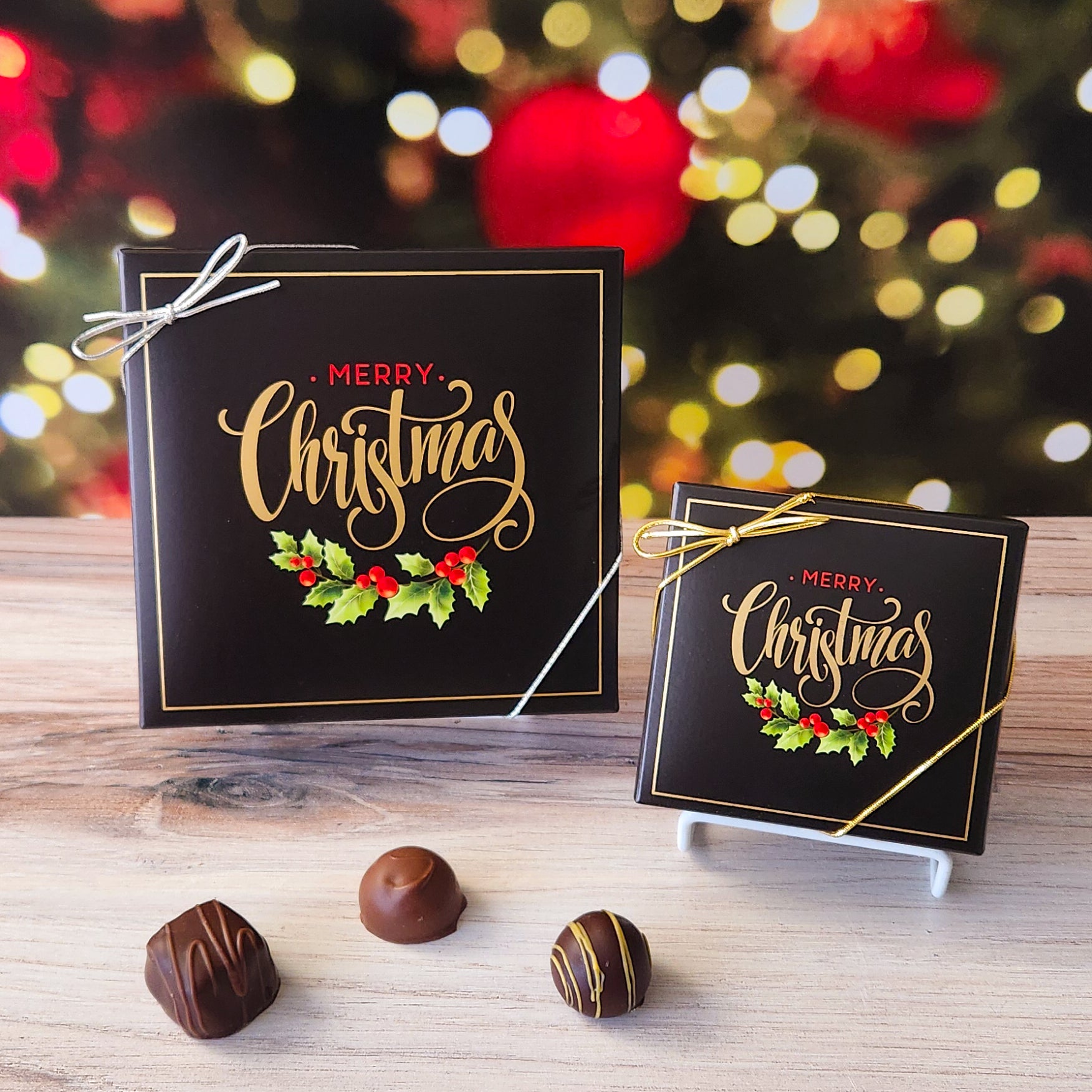 An assortment of our most popular milk and dark chocolate creams, caramels, melt-aways, and truffles all packed inside a box with the saying "Merry Christmas" written above some festive holly leaves printed on the cover.