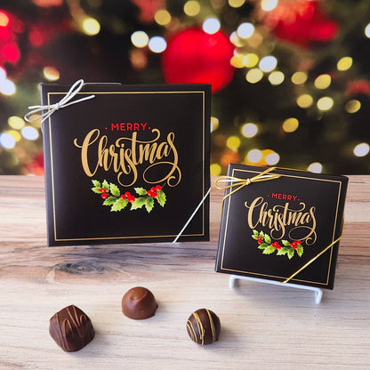 An assortment of our most popular milk and dark chocolate creams, caramels, melt-aways, and truffles all packed inside a box with the saying "Merry Christmas" written above some festive holly leaves printed on the cover.