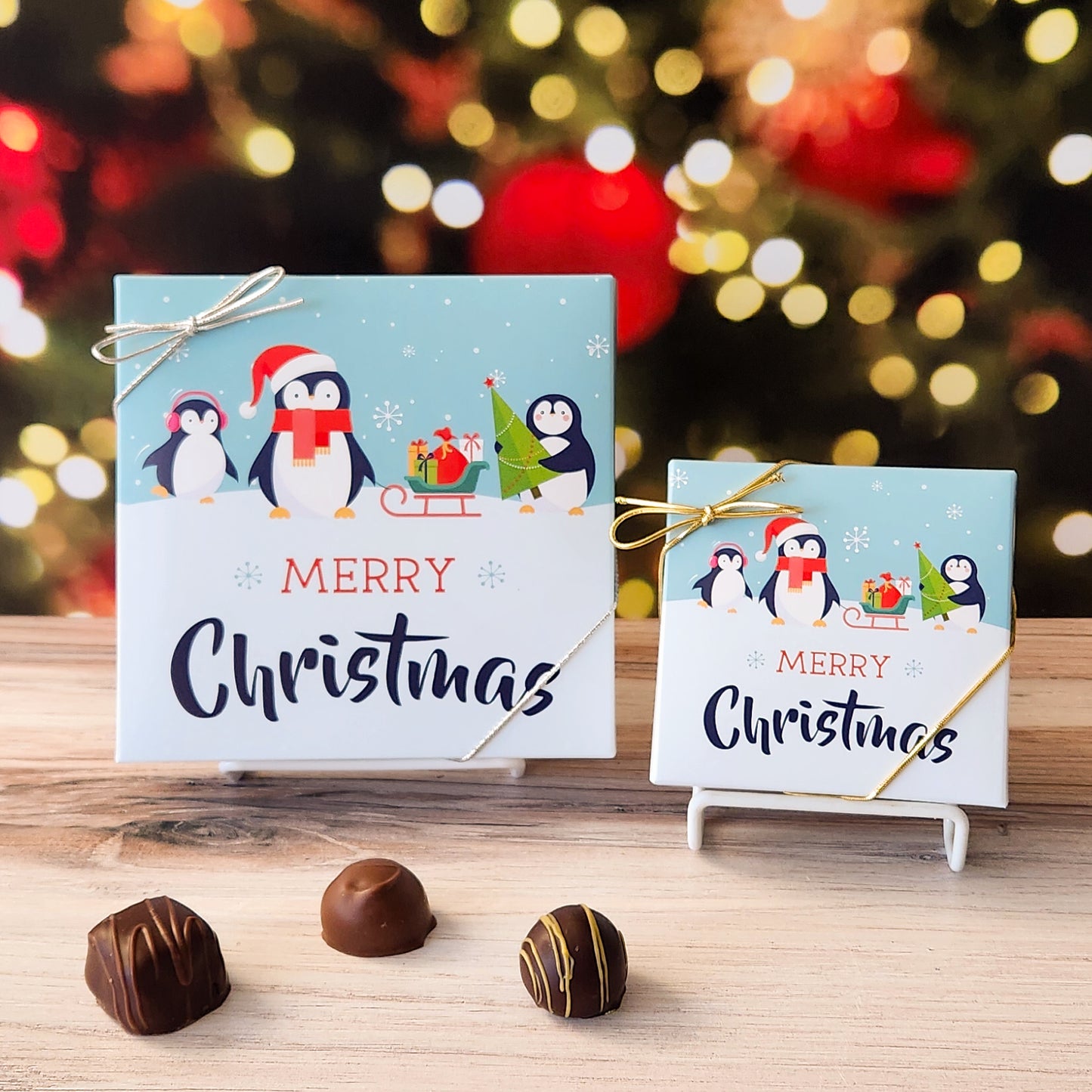 An assortment of our most popular milk and dark chocolate creams, caramels, melt-aways, and truffles all packed inside a box with the saying "Merry Christmas" and festive penguins on the cover.