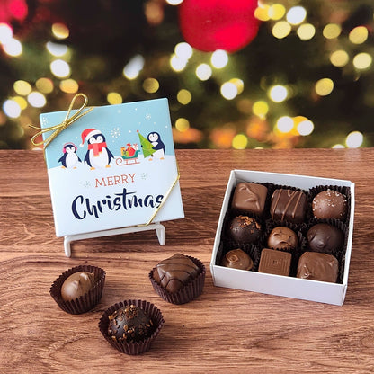 9 Piece chocolate assortment in Merry Christmas with Penguins decorative box.  filled with a variety of creams, caramels, melt-aways and  truffles.