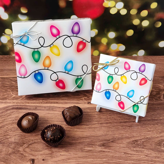 Chocolate assortment in decorative box with holiday lights.  filled with a variety of creams, caramels, melt-aways and  truffles.
Available in 9 or 16 piece boxes