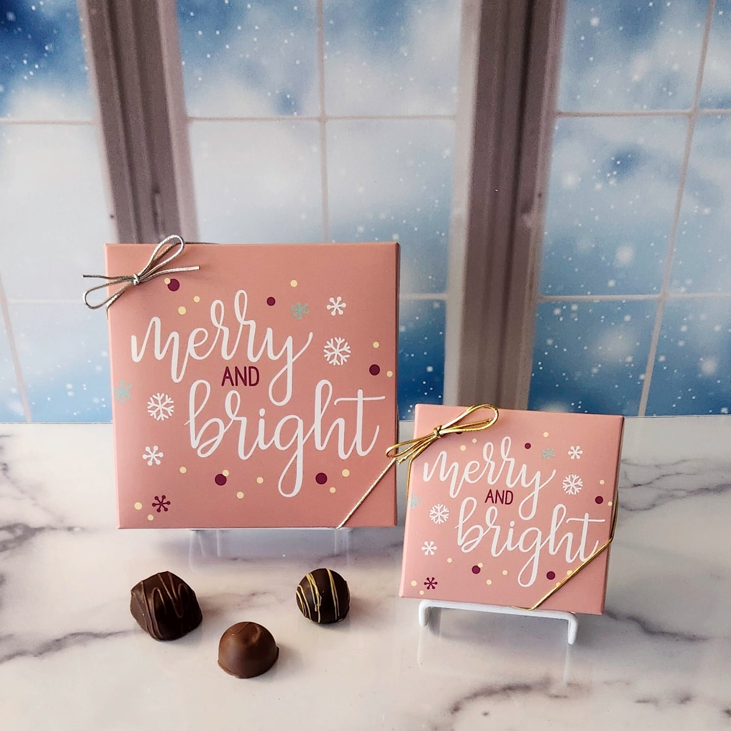 An assortment of our most popular milk and dark chocolate creams, caramels, melt-aways, and truffles all packed inside a box with the saying "Merry and Bright" written on the cover.