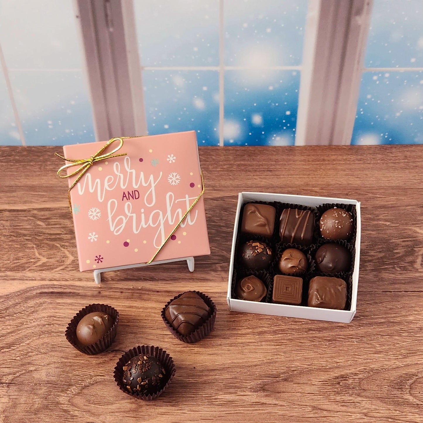 9 Piece  Merry and Bright Holiday Chocolate Box.  Inside, you'll find a handpicked assortment of our most popular milk and dark chocolates. Think creamy centers, buttery caramels, dreamy melt-aways, and decadent truffles