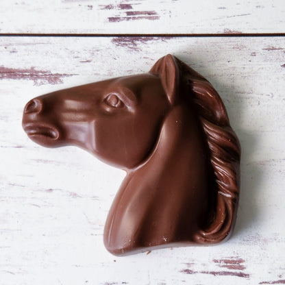 A creamy milk chocolate horse head favor.