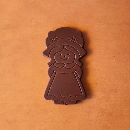 Celebrate Thanksgiving with our charming Girl Pilgrim Chocolate Favor, a delightful addition to any holiday table! Available in smooth milk chocolate or bold dark chocolate, this adorable pilgrim-shaped treat adds a touch of tradition and sweetness to your festivitie