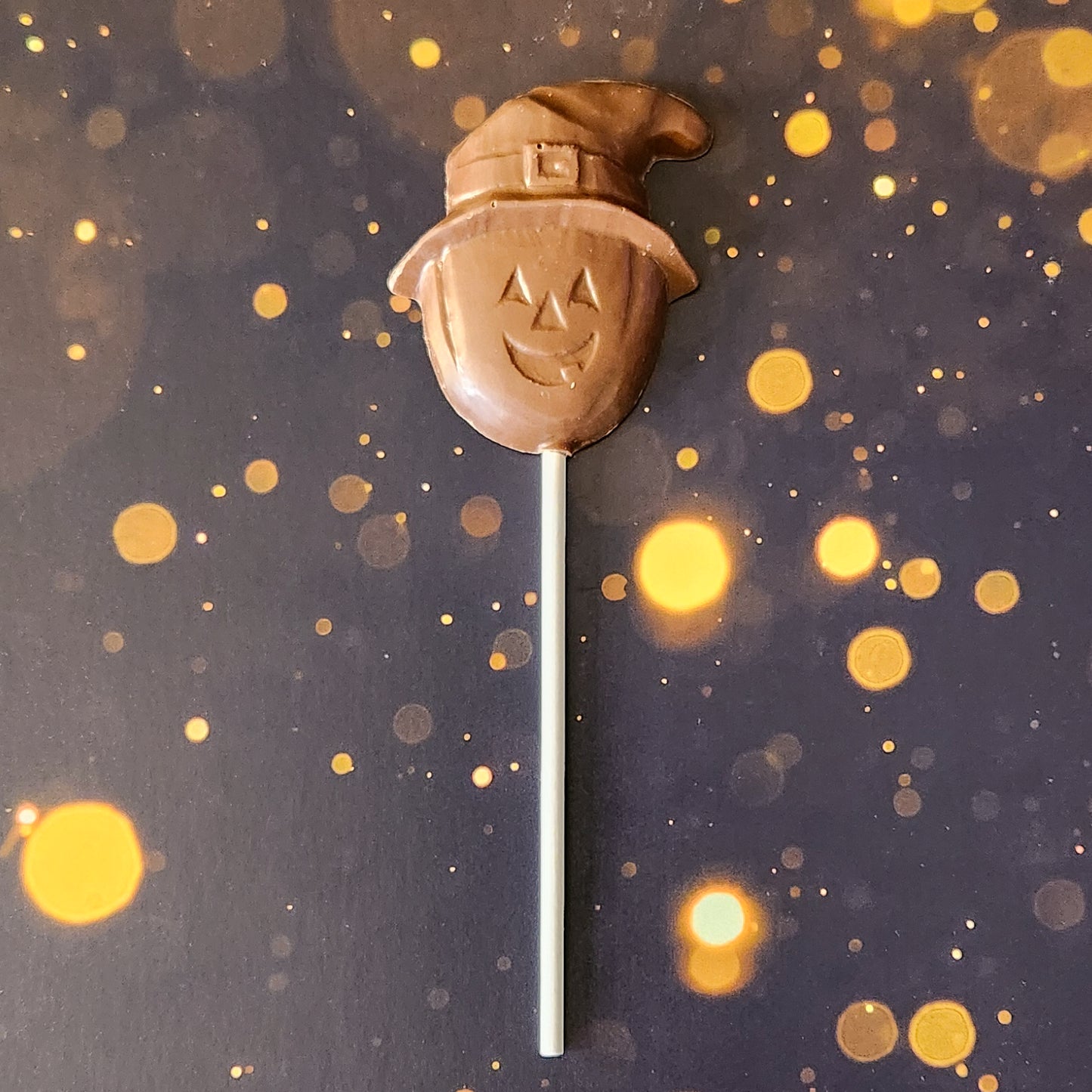 Milk chocolate pumpkin with witch hat lollipop