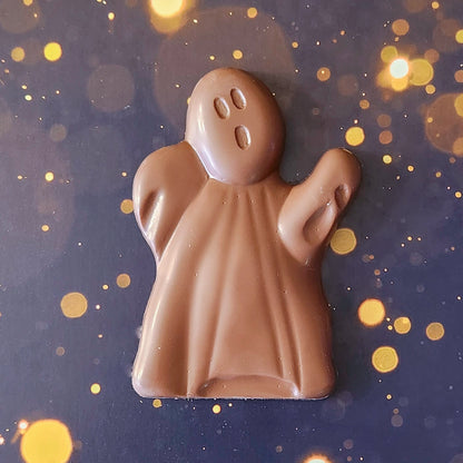 One Haunted Chocolate Ghost made of milk chocolate.  Comes packaged in a clear bag tied with an orange bow, showcasing its festive Halloween theme. 