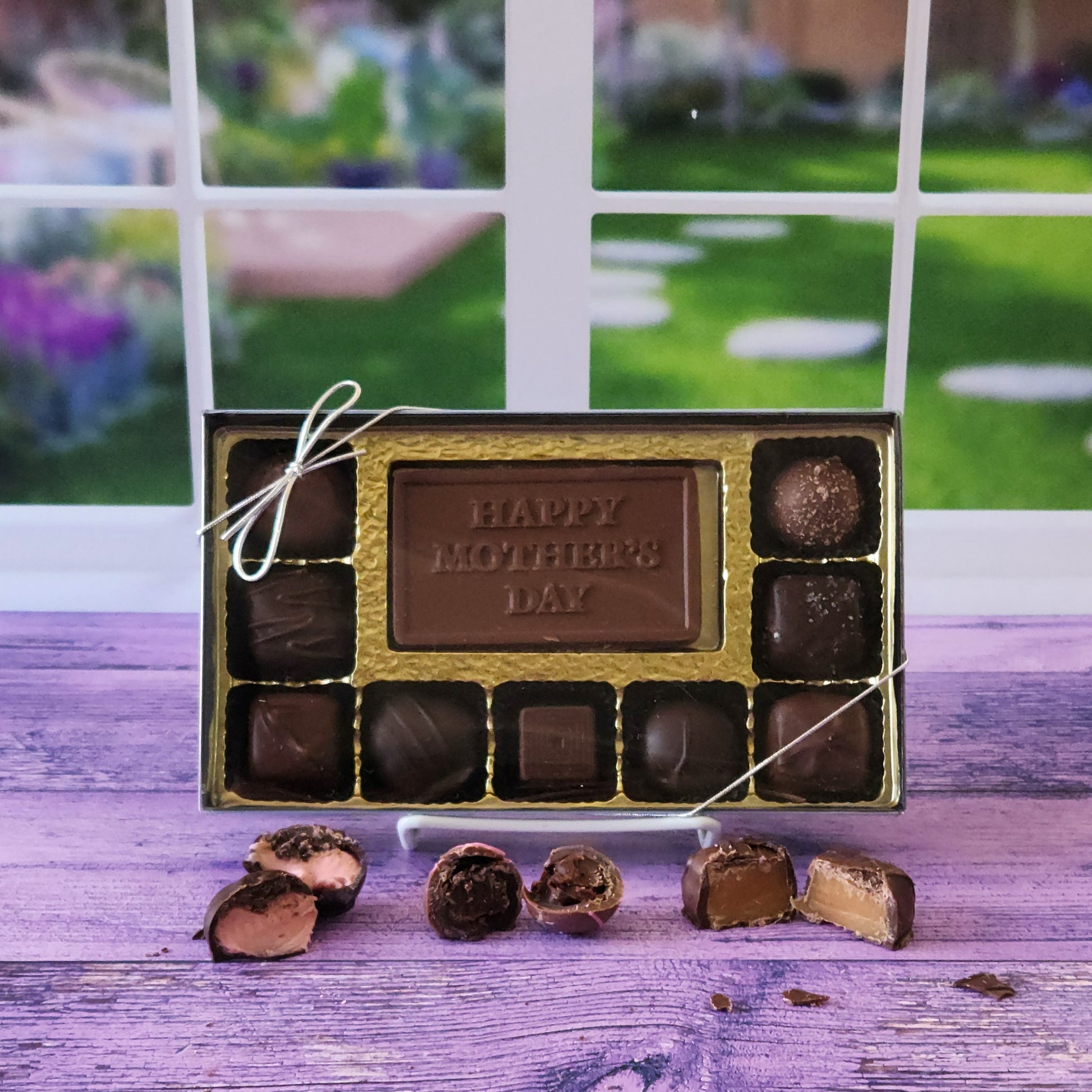 Milk Chocolate card that says Happy Mother's Day surrounded by 9 of Stage Stop Candy's most popular creams, caramels, truffles and meltaways.