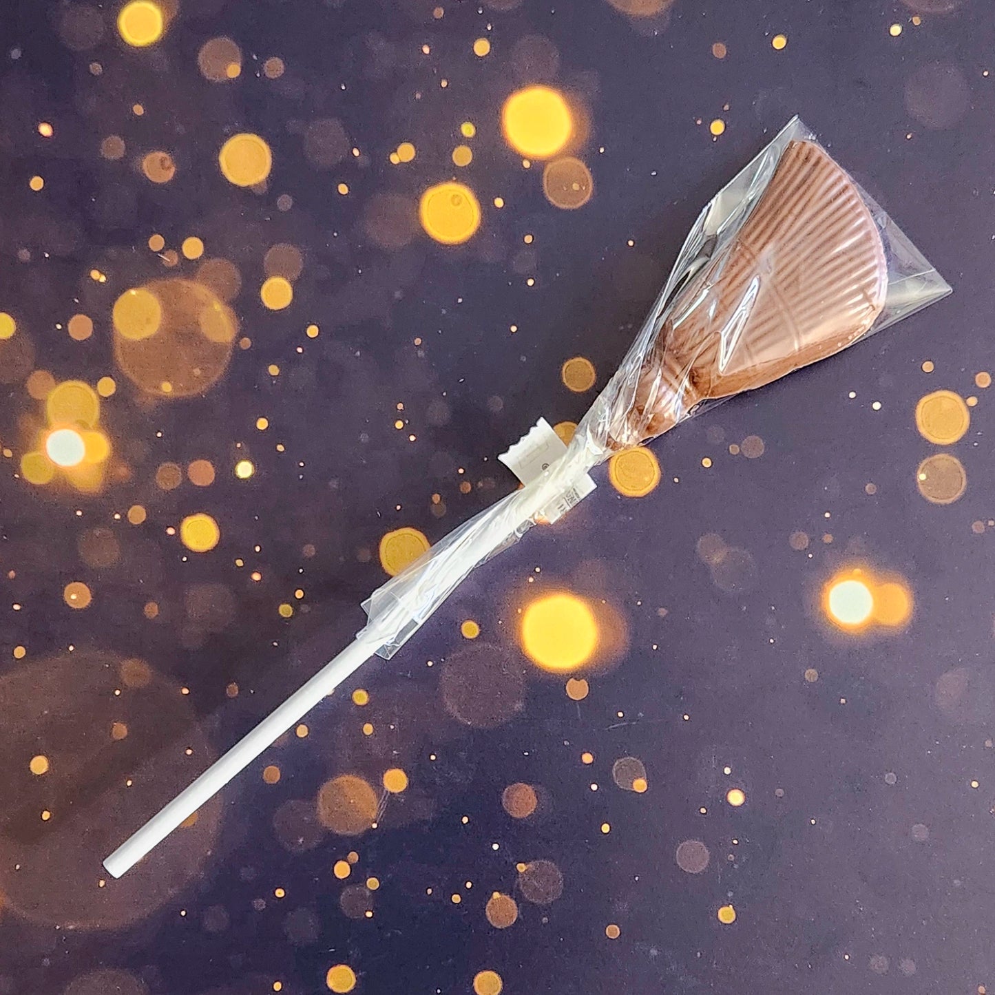 Unleash your inner wizard with our Chocolate Nimbus! Shaped like a broomstick, this delicious milk chocolate lollipop is perfect for fans of all things magical.