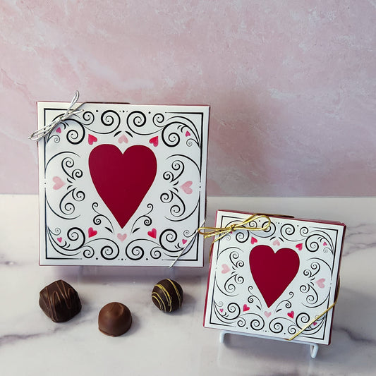 An assortment of our most popular milk and dark chocolate creams, caramels, melt-aways, and truffles all packed inside a festive box. On the cover of the box an ornate hearts are printed.