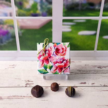 An assortment of our most popular milk and dark chocolate creams, caramels, melt-aways, and truffles all packed inside a painted peonies printed box.