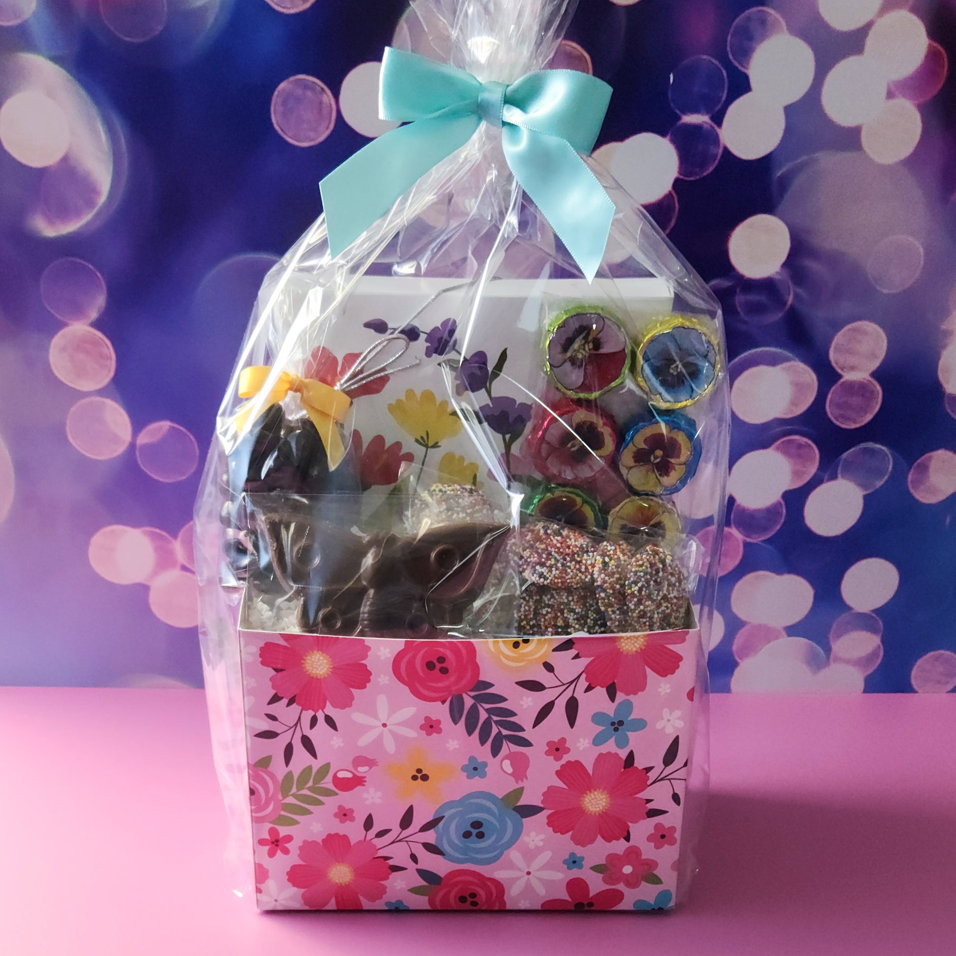A chocolate gift basket with a floral theme. Perfect for any occasion.