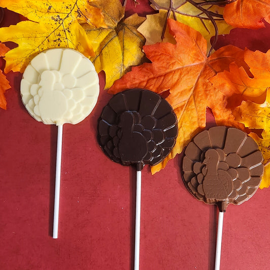 Dark, White and Milk Round Turkey Lollipops on a festive fall background