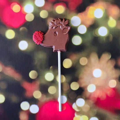 Bring some holiday magic to your candy lineup with our Rudolph Lollipop! Made from creamy Milk Chocolate, this festive lollipop is shaped like everyone’s favorite reindeer and features Rudolph’s famous red nose, decorated with cheerful red nonpareils for a fun, playful touch