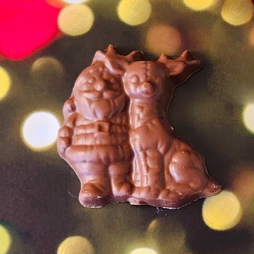 Celebrate the magic of the season with our Milk Chocolate Santa and Reindeer favor! This delightful treat features a charming design of Santa and his trusty reindeer, crafted from creamy milk chocolate. 