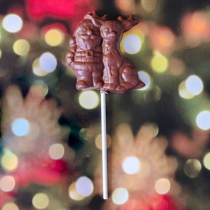 Celebrate the magic of the season with our Milk Chocolate Santa and Reindeer lollipop! This delightful treat features a charming design of Santa and his trusty reindeer, crafted from creamy milk chocolate. 