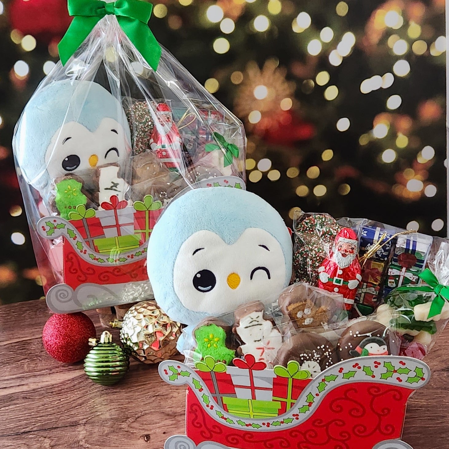 Santa's Sleigh Gift Basket from Stage Stop Candy includes an adorable stuffed penguin and festive holiday treats. 