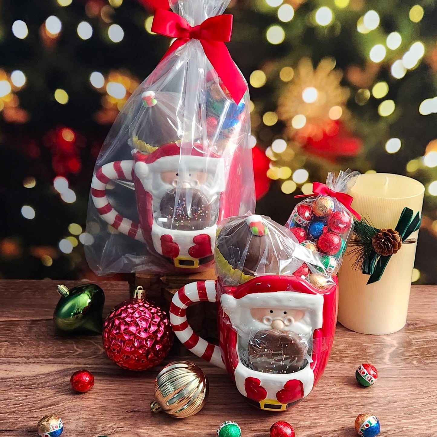The Santa with Cookie Gift Mug set from Stage Stop Candy includes a delightful ceramic mug with an adorable Santa design, complete with a milk chocolate shortbread cookie, hot cocoa bomb, and foiled ornaments. 