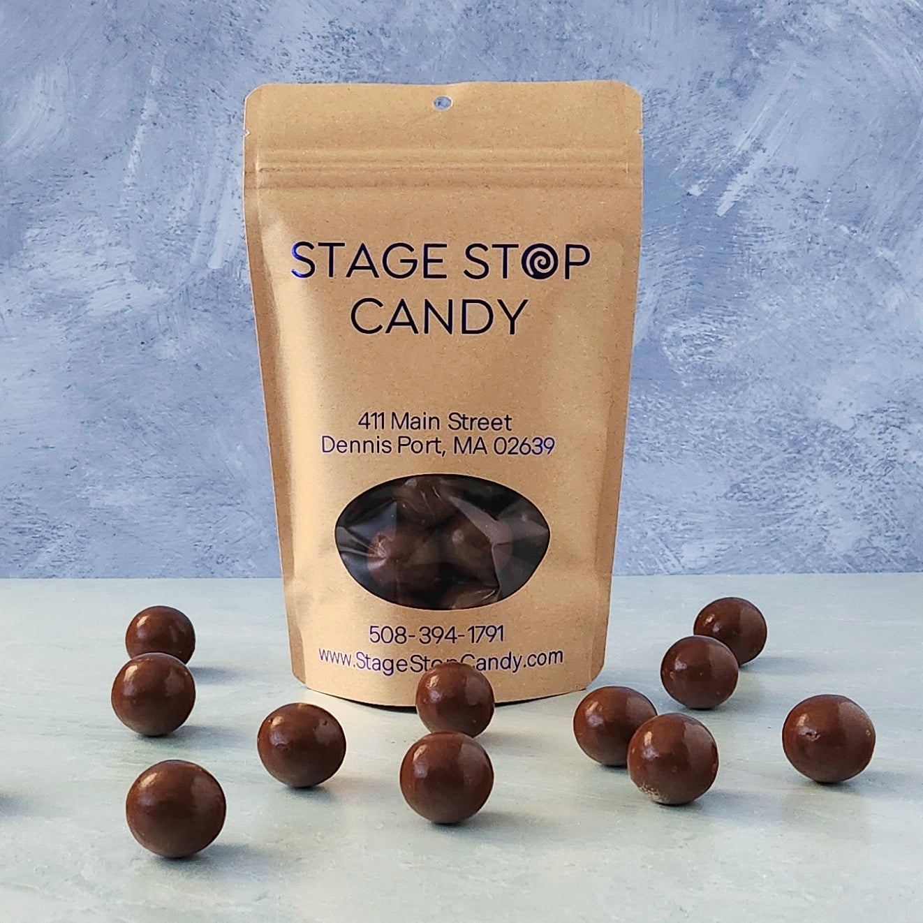 Stage Stop Candy packaging with chocolate candies on a gray surface and textured background