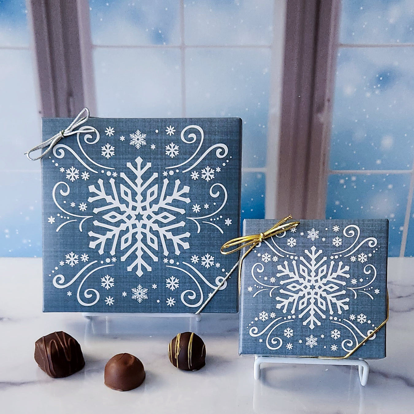 An assortment of our most popular milk and dark chocolate creams, caramels, melt-aways, and truffles all packed inside a box with an elegant snowflake pattern on the cover.