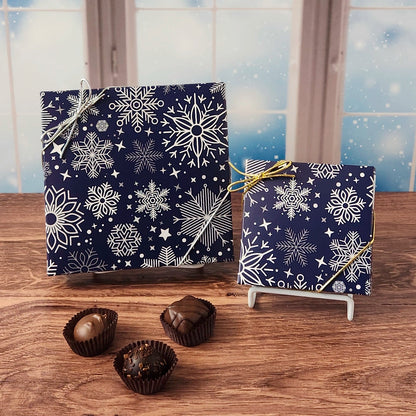 Winter Snowflakes Chocolate Assortment.  Inside this decorative box is a handpicked selection of our most popular milk and dark chocolates. You’ll discover a variety of gooey caramels, rich truffles, creamy centers, and smooth melt-aways.  Available in your choice of 9 or 16 pieces