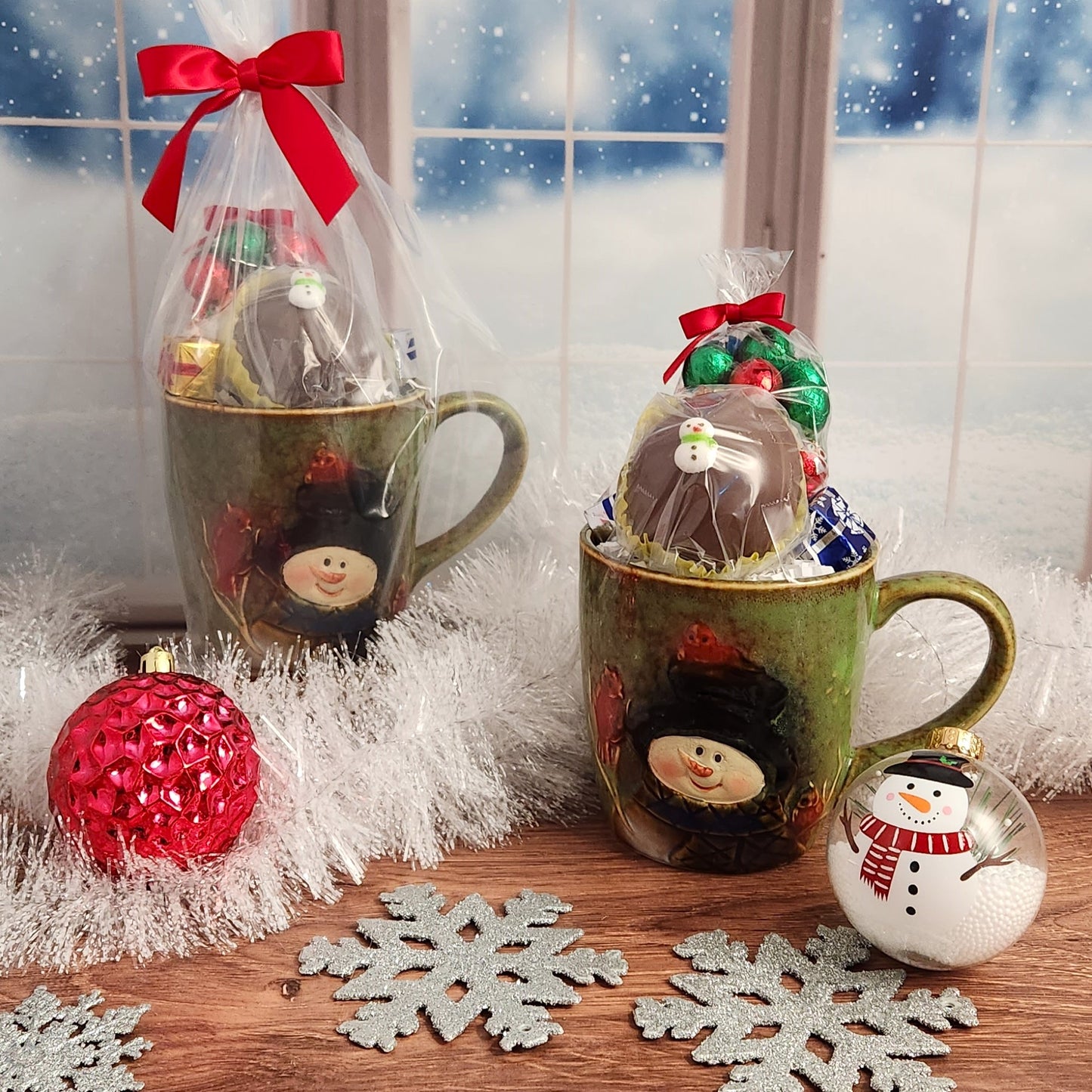 Snowman Stoneware Mug filled with 4 oz. Milk Chocolate Foiled Ornaments and a Hot Cocoa Bomb - Perfect for warming up by the fire during the holidays!