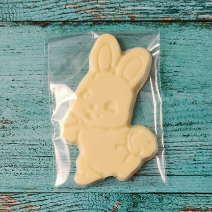 White chocolate bunny shaped like a rabbit on a rustic wooden surface