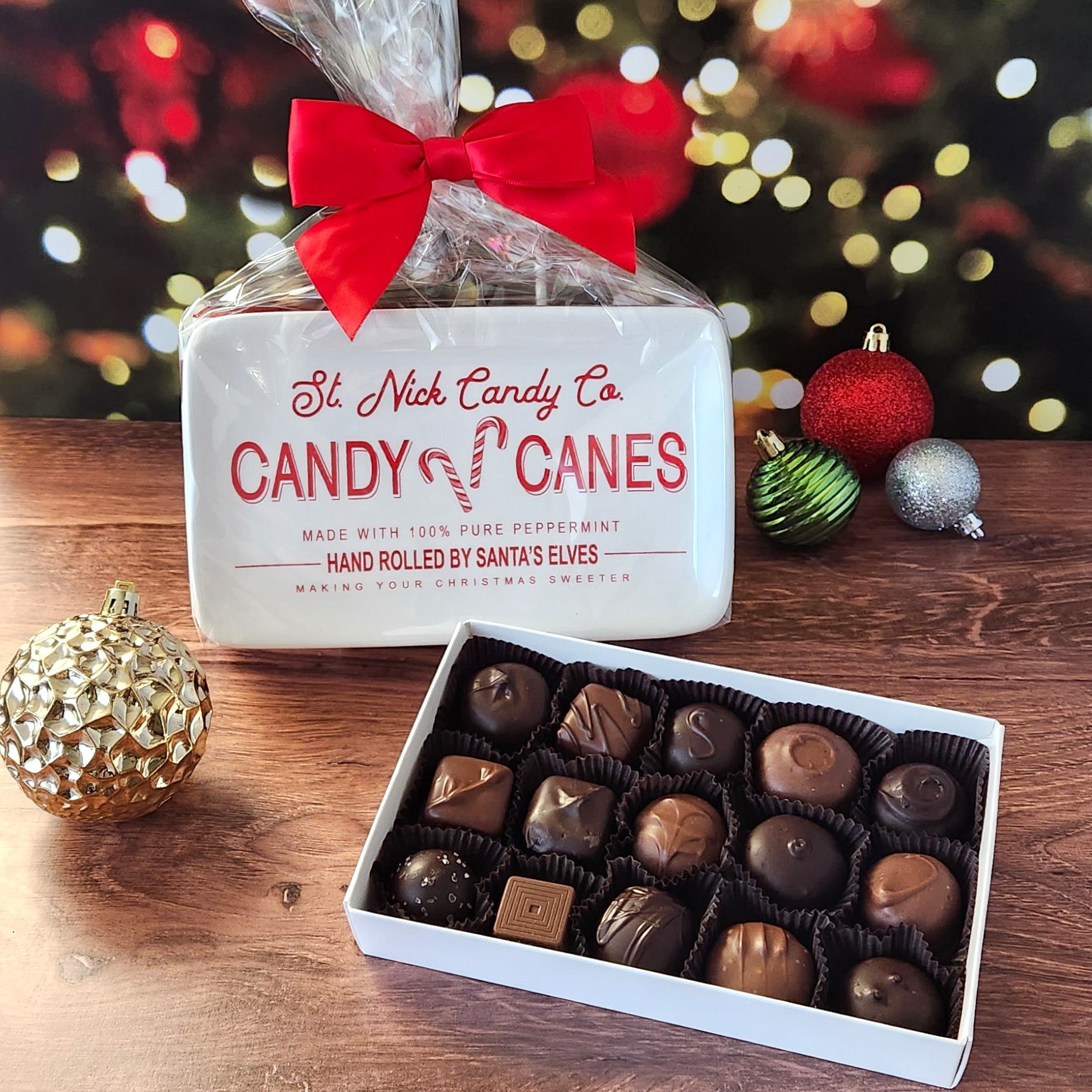 Enjoy  a 15 piece popular assortment of Stage Stop Candy's milk and dark chocolates on a candy tray saying "St. Nick Candy Co. Candy Canes"