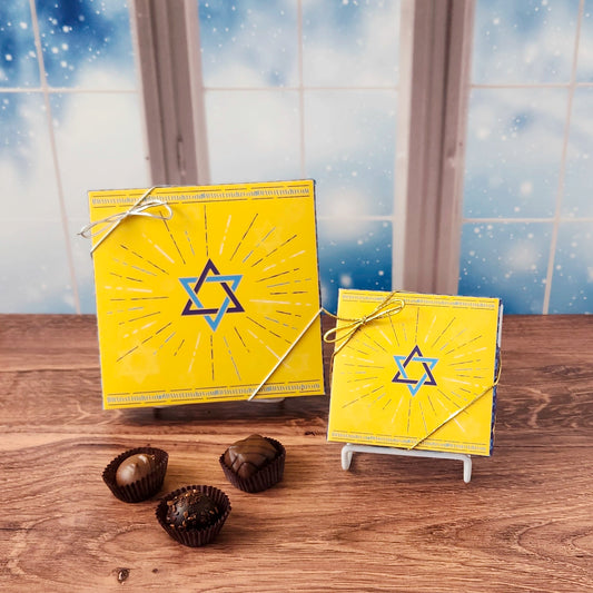 Star Of David Chocolate Assortment.  Inside this festive box is a handpicked selection of our most popular milk and dark chocolates. You’ll discover a variety of gooey caramels, rich truffles, creamy centers, and smooth melt-aways.  Available in your choice of 9 or 16 piece boxes