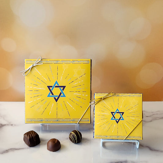 An assortment of our most popular milk and dark chocolate creams, caramels, melt-aways, and truffles all packed inside a box with the Star of David printed on it.