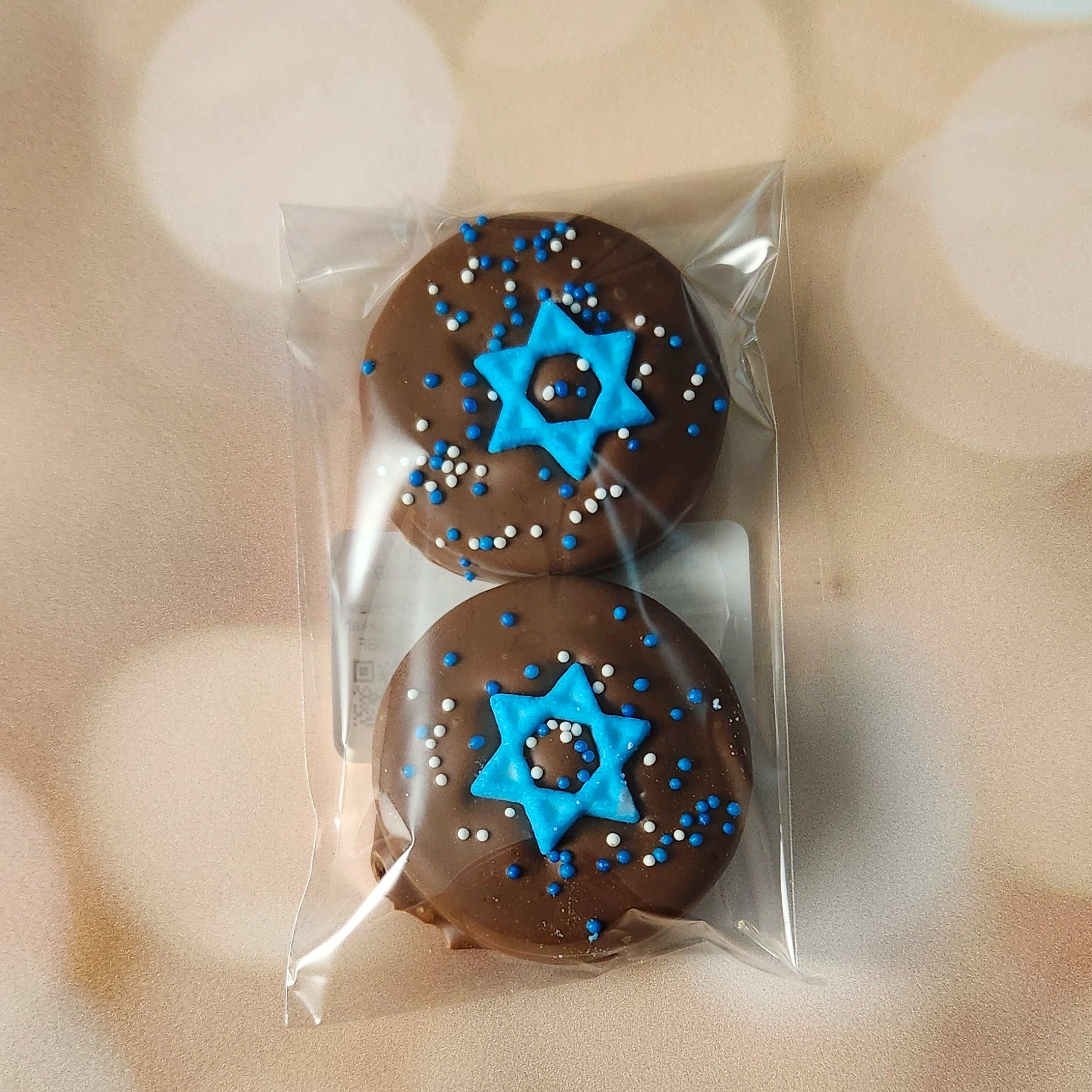 Celebrate Hanukkah with a delicious twist on a classic favorite! Our Hanukkah Themed Milk Chocolate Covered Oreos are dipped in creamy milk chocolate and decorated with festive holiday designs to honor the season. Packaged in a convenient two-pack, these treats are perfect for sharing, gifting, or savoring during your Hanukkah celebrations