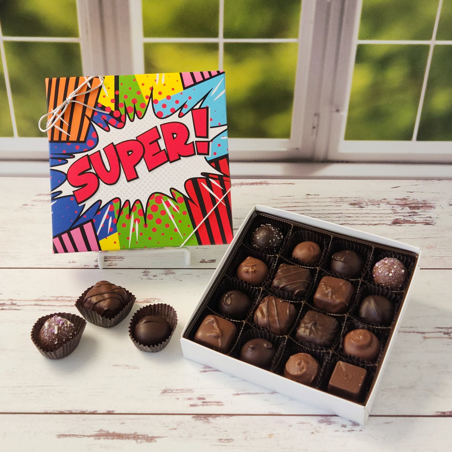 Get ready to savor a chocolate experience that’s as fun as it is delicious with our Milk & Dark Chocolate Popular Assortment! This tempting collection comes in your choice of a 9-piece or 16-piece box, both decorated with a vibrant Super print on the cover that makes it just as delightful to give as it is to receive. Inside, you’ll find a mouthwatering mix of milk and dark chocolate treats that are perfect for satisfying any craving. 