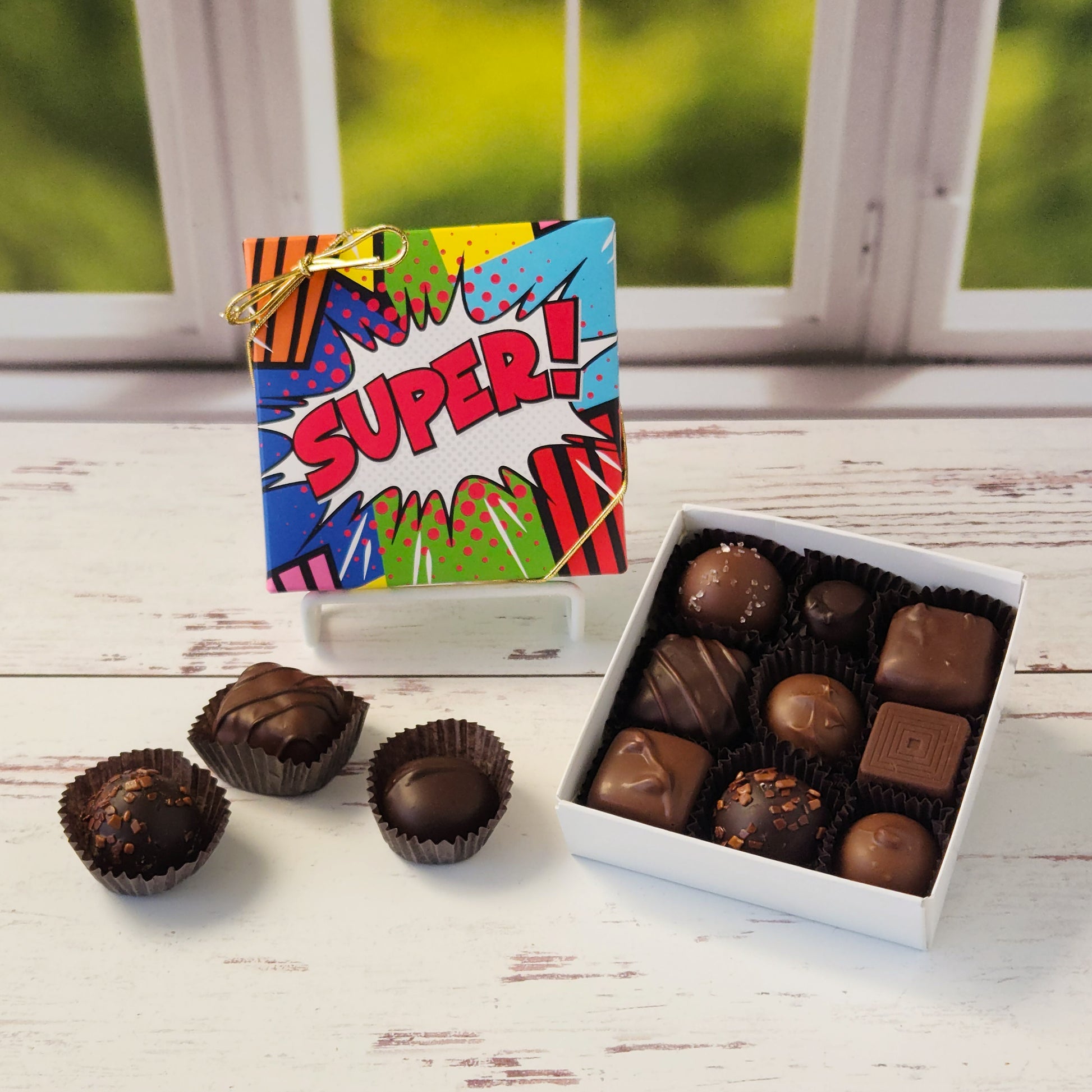 Get ready to savor a chocolate experience that’s as fun as it is delicious with our Milk & Dark Chocolate Popular Assortment! This tempting collection comes in your choice of a 9-piece or 16-piece box, both decorated with a vibrant Super print on the cover that makes it just as delightful to give as it is to receive. Inside, you’ll find a mouthwatering mix of milk and dark chocolate treats that are perfect for satisfying any craving. 