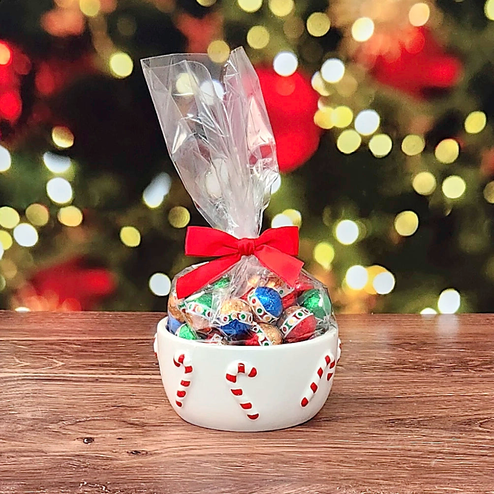 Sweet Tidings Candy Dish, the Candy Cane bowl, front view, with foil-wrapped chocolates bagged with a red bow