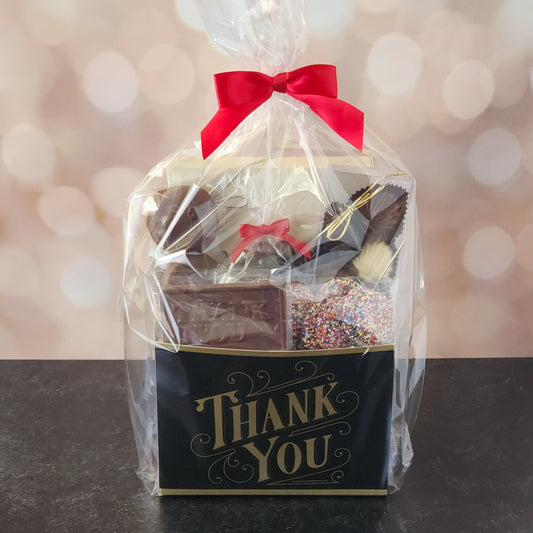 This Black and Gold Thank You Gift Basket is filled with a variety of delicious treats, including:
Milk Chocolate Covered Oreos, Milk Chocolate Nonpareils, A "Thank You" Milk Chocolate Bar, Chocolate Shell Sampler Box and a 16-Piece Milk and Dark Chocolate Assortment.

Perfect for coworkers, teachers, clients, friends, or anyone who deserves a sweet token of appreciation, this basket is sure to leave a lasting impression!