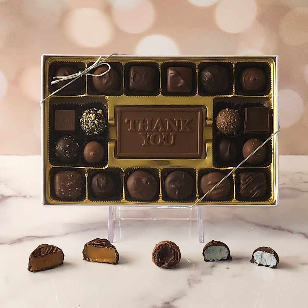 Show your appreciation with our 20-piece Thank You Candy Box! Inside, a beautifully crafted milk chocolate card that says "Thank You" is surrounded by a delectable assortment of milk and dark chocolate soft center creams, luxurious truffles, and luscious caramels. It's the perfect way to express your gratitude and make someone's day extra special!