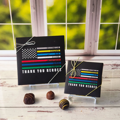 An assortment of our most popular milk and dark chocolate creams, caramels, melt-aways, and truffles all packed inside a box with the words Thank You Heros are printed on this box. 