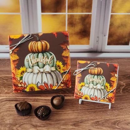Celebrate the sweetness of the season with our Thankful Fall Chocolate Assortment!  Available in a 9-piece or 16-piece box, this collection is filled with rich milk and dark chocolates, crafted in small batches right here in our candy kitchen.  Each bite is a surprise of flavor and texture, featuring silky creams, gooey caramels, melt-in-your-mouth meltaways, and decadent truffles that capture everything we love about fall.
