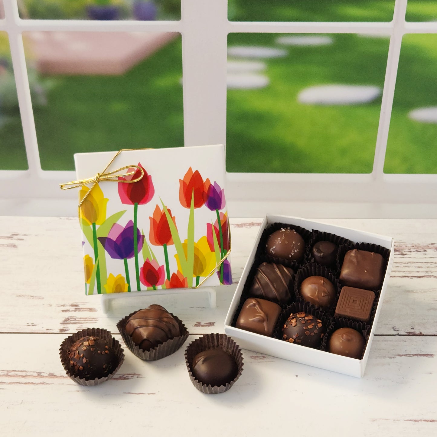 Say it with flowers—and chocolate! Our 9 piece Tulips Chocolate Box is a delightful way to brighten someone’s day with a beautiful blend of sights and tastes. Featuring a cheerful tulip design on the cover, this box is packed with Stage Stop Candy’s popular assortment of milk and dark chocolates. Handcrafted in small batches at our family-run Cape Cod shop, each piece is made with care to deliver that fresh, irresistible flavor we’re known for.