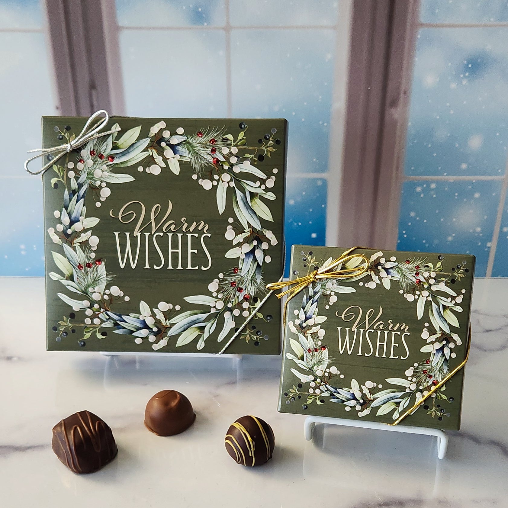 An assortment of our most popular milk and dark chocolate creams, caramels, melt-aways, and truffles all packed inside a box with the words "Warm Wishes" surrounded by an elegant wreath printed on the cover.