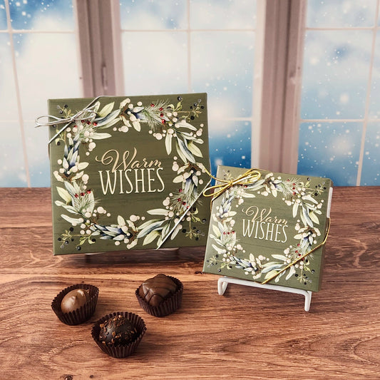 Warm Wishes Chocolate Box.  A festive assortment of our most popular milk and dark chocolates, available in your choice of a 9 or 16 piece box.   Inside, you’ll discover a handcrafted variety of gooey caramels, rich truffles, creamy centers, and smooth melt-aways.